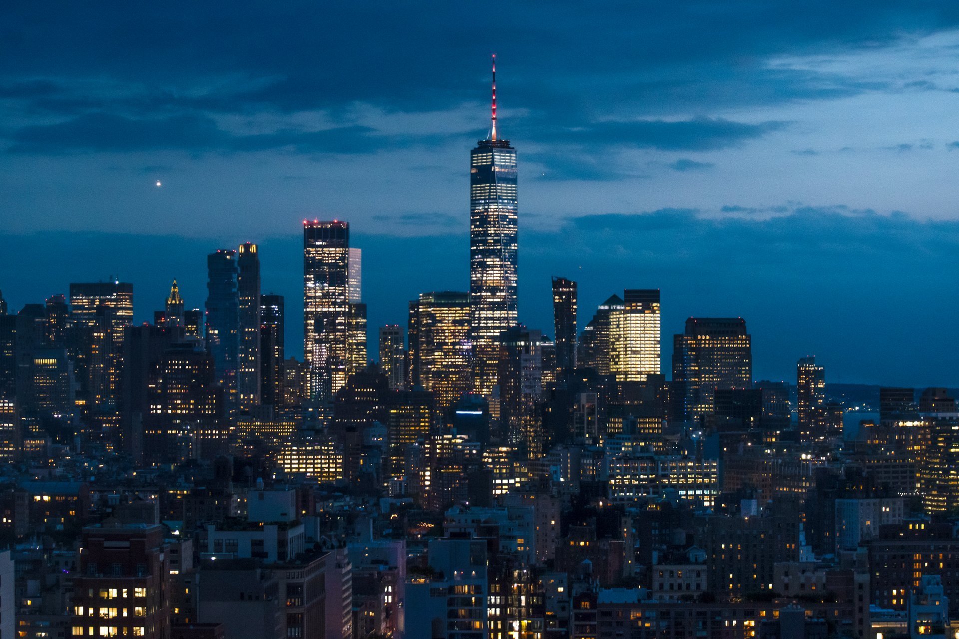 Downtown Manhattan skyline at blue hour showcasing success and ambition