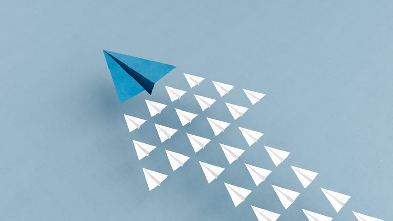 Paper planes flying in arrow up formation